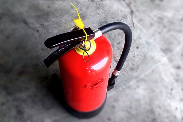 Man is reaching his hand to push fire alarm hand station